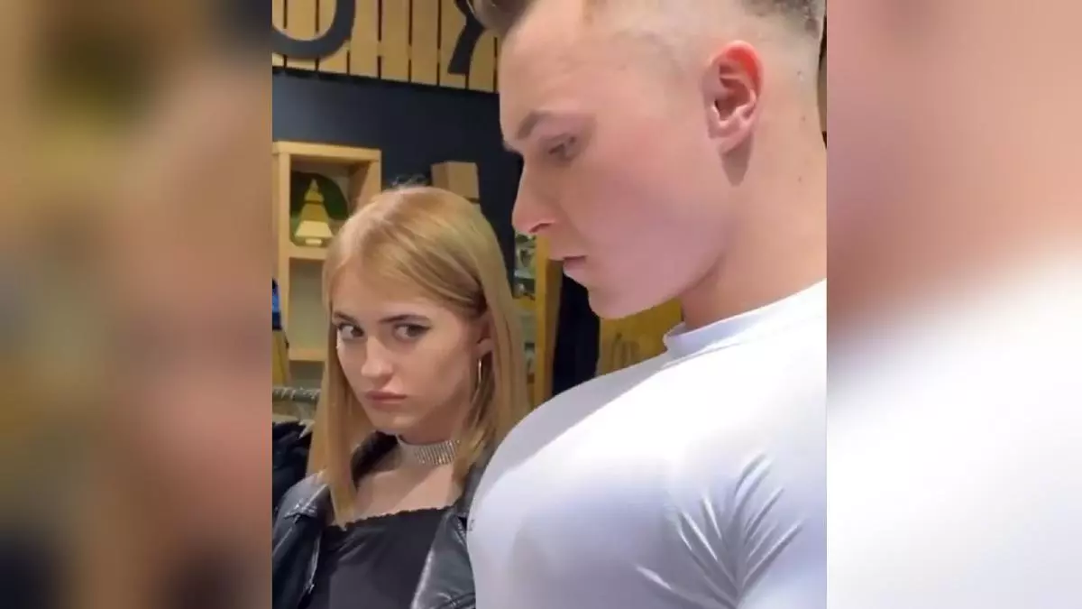 girl staring at guys chest meme image