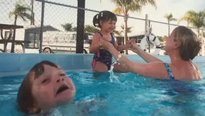 mother ignoring kid drowning in a pool